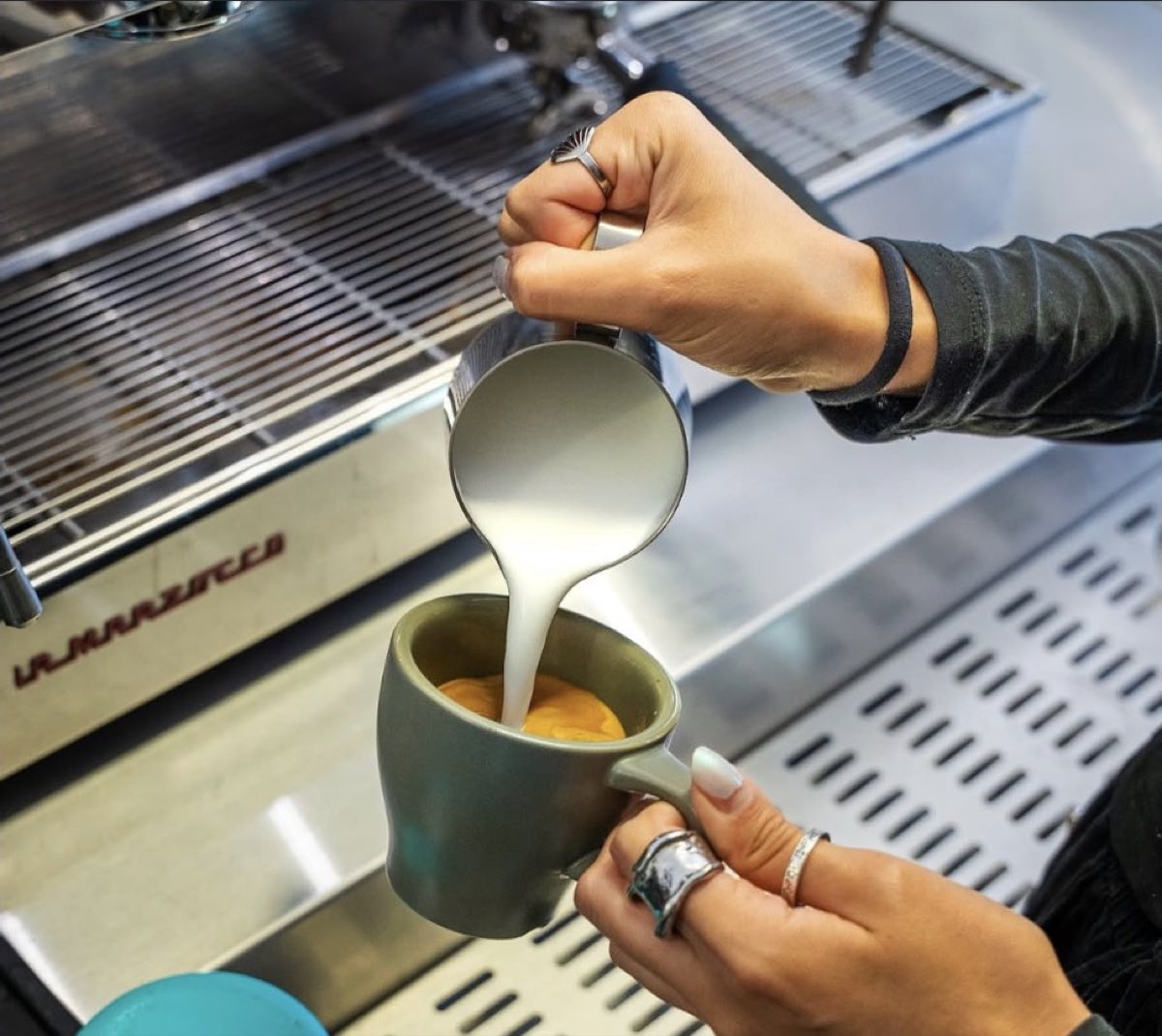Milk being poured into a coffee at X's + O's