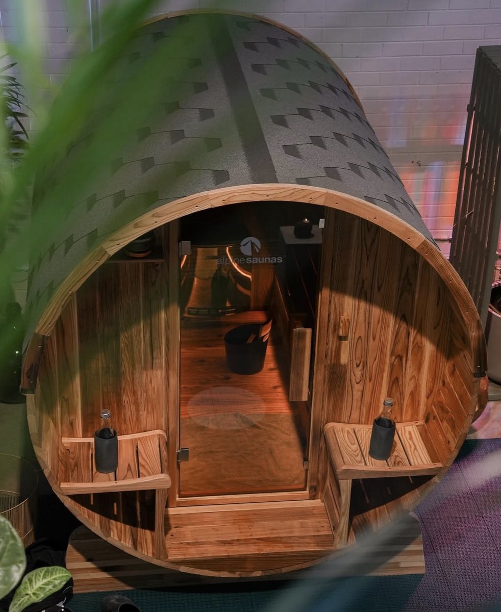 Barrel-shaped Finnish sauna with its door open at Ark Sports Club